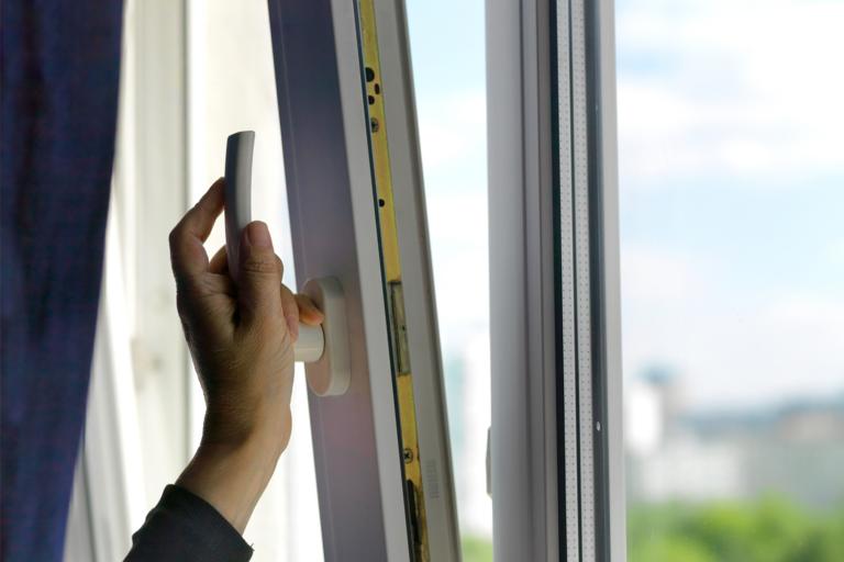 woman opening window for fresh air